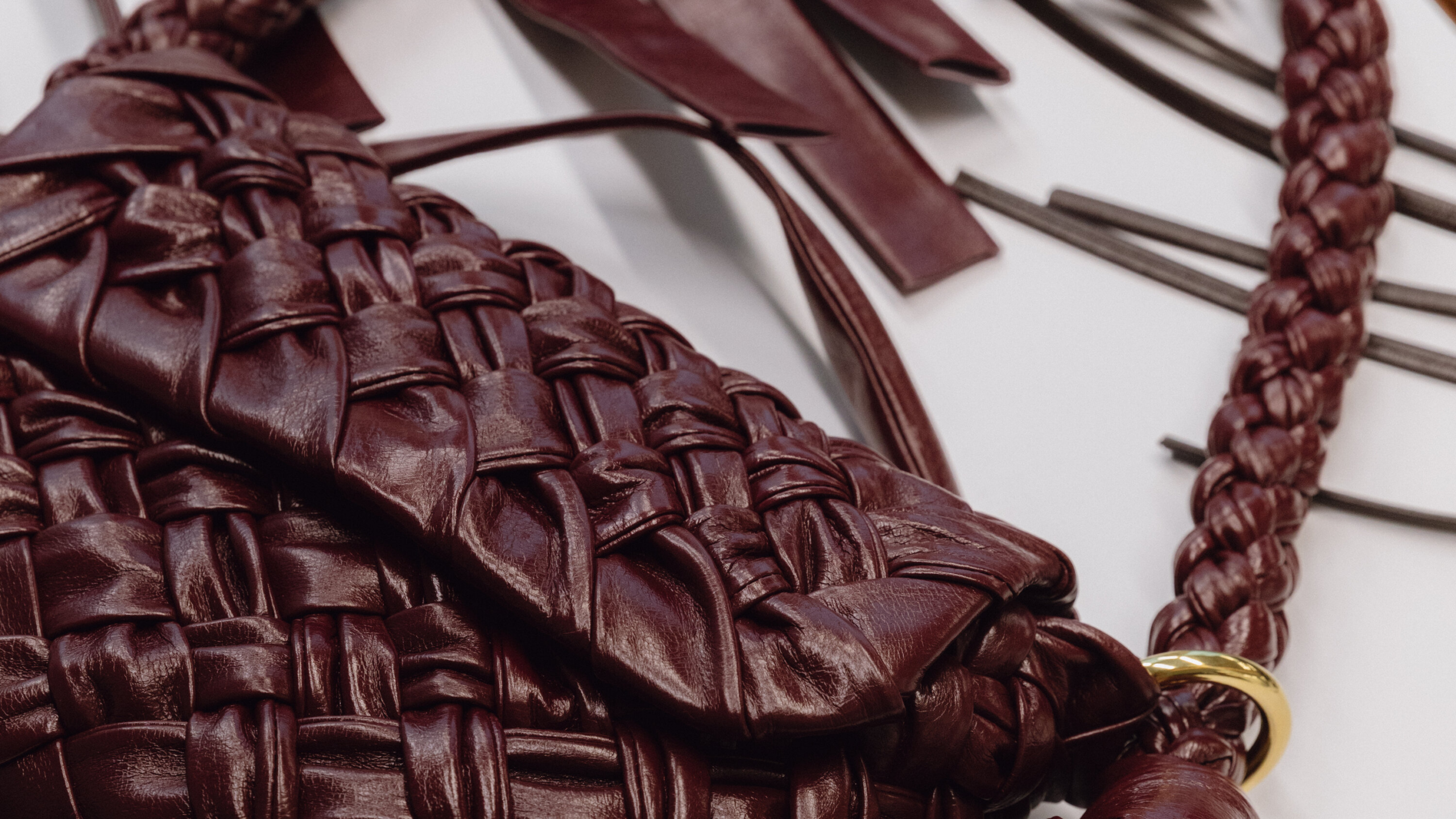 Home 7 A craftsman mid-stitch, transforming leather into a bag that looks like it flew first class from Paris — but didn’t.