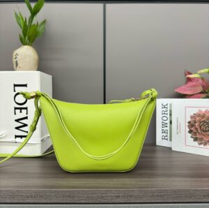 Mini Hammock Hobo. Authentic quality luxury bag crafted in genuine leather comes with authenticity card, dust bag and gift bag. Effortless Form, Everyday Function. The Mini Hammock Hobo is a contemporary reimagining of *oewe’s iconic Hammock bag. This streamlined variation offers a sleek, sculptural silhouette designed as a versatile sling bag for modern living. Expertly crafted in classic calfskin, it features soft, supple leather and a compact form that adapts effortlessly to your day. The unique design allows for multiple carry options—wear it crossbody, over the shoulder, or by hand. Elegant yet functional, this mini hobo is perfect for essentials, making it an ideal choice for both daily wear and minimalist style statements.