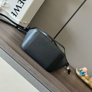 Mini Hammock Hobo. Authentic quality luxury bag crafted in genuine leather comes with authenticity card, dust bag and gift bag. Effortless Form, Everyday Function. The Mini Hammock Hobo is a contemporary reimagining of *oewe’s iconic Hammock bag. This streamlined variation offers a sleek, sculptural silhouette designed as a versatile sling bag for modern living. Expertly crafted in classic calfskin, it features soft, supple leather and a compact form that adapts effortlessly to your day. The unique design allows for multiple carry options—wear it crossbody, over the shoulder, or by hand. Elegant yet functional, this mini hobo is perfect for essentials, making it an ideal choice for both daily wear and minimalist style statements.