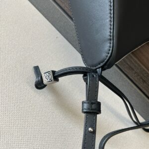 Mini Hammock Hobo. Authentic quality luxury bag crafted in genuine leather comes with authenticity card, dust bag and gift bag. Effortless Form, Everyday Function. The Mini Hammock Hobo is a contemporary reimagining of *oewe’s iconic Hammock bag. This streamlined variation offers a sleek, sculptural silhouette designed as a versatile sling bag for modern living. Expertly crafted in classic calfskin, it features soft, supple leather and a compact form that adapts effortlessly to your day. The unique design allows for multiple carry options—wear it crossbody, over the shoulder, or by hand. Elegant yet functional, this mini hobo is perfect for essentials, making it an ideal choice for both daily wear and minimalist style statements.