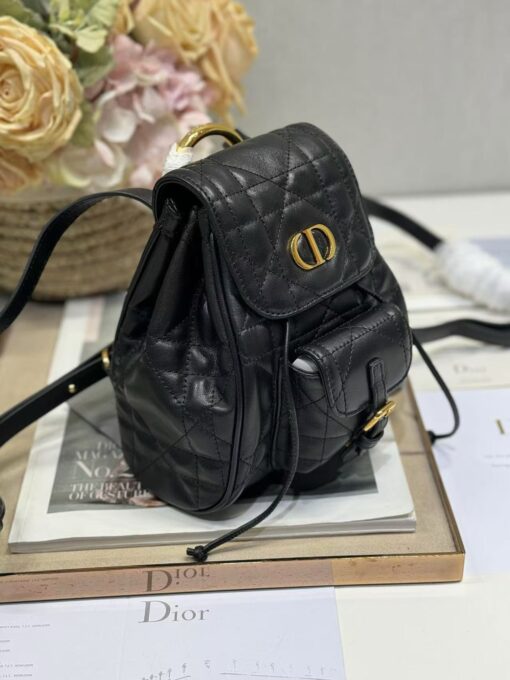 Small Caro Backpack. Authentic quality luxury bag crafted in genuine leather comes with authenticity card, dust bag and gift bag. Elegance Meets Effortless Edge. Elevate your everyday with the Small Caro Backpack — a flawless blend of modern femininity and iconic House craftsmanship. Luxuriously crafted in lambskin, its supple silhouette is enhanced by bold Macrocannage topstitching that whispers timeless *ior style. The antique gold-finish ‘CD’ clasp opens to a drawstring main compartment, perfectly balancing beauty and practicality. A discreet flap pocket keeps your daily essentials close at hand, while the top handle and adjustable leather straps offer versatile, all-day comfort. Whether slung over your shoulder or carried by hand, this petite powerhouse delivers Parisian polish in every step.