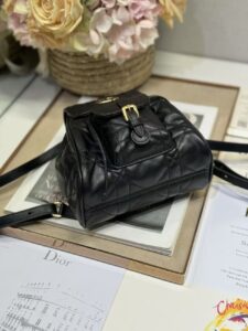 Small Caro Backpack. Authentic quality luxury bag crafted in genuine leather comes with authenticity card, dust bag and gift bag. Elegance Meets Effortless Edge. Elevate your everyday with the Small Caro Backpack — a flawless blend of modern femininity and iconic House craftsmanship. Luxuriously crafted in lambskin, its supple silhouette is enhanced by bold Macrocannage topstitching that whispers timeless *ior style. The antique gold-finish ‘CD’ clasp opens to a drawstring main compartment, perfectly balancing beauty and practicality. A discreet flap pocket keeps your daily essentials close at hand, while the top handle and adjustable leather straps offer versatile, all-day comfort. Whether slung over your shoulder or carried by hand, this petite powerhouse delivers Parisian polish in every step. | PURSE POP UP LIVE Small Caro Backpack. Authentic quality luxury bag crafted in genuine leather comes with authenticity card, dust bag and gift bag. Elegance Meets Effortless Edge. Elevate your everyday with the Small Caro Backpack — a flawless blend of modern femininity and iconic House craftsmanship. Luxuriously crafted in lambskin, its supple silhouette is enhanced by bold Macrocannage topstitching that whispers timeless *ior style. The antique gold-finish ‘CD’ clasp opens to a drawstring main compartment, perfectly balancing beauty and practicality. A discreet flap pocket keeps your daily essentials close at hand, while the top handle and adjustable leather straps offer versatile, all-day comfort. Whether slung over your shoulder or carried by hand, this petite powerhouse delivers Parisian polish in every step.