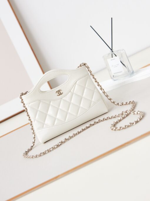 31 Nano Shopping Bag. Authentic quality luxury bag crafted in genuine leather comes with authenticity card, dust bag and gift bag. Small in size, grand in statement. A miniature marvel that captures the sophistication of *ANEL in its most playful form. Crafted with meticulous precision, this petite icon merges the timeless spirit of the *ANEL 31 with a modern twist on everyday elegance. Designed in supple lambskin and finished with gleaming gold-tone hardware, the Nano 31 doesn’t just carry your essentials — it carries your attitude. Whether worn crossbody, by hand, or dangling from the crook of your arm, this charming piece elevates every ensemble with a whisper of Parisian chic. Perfect for a night out or a day in the spotlight, it’s not just a bag — it’s your boldest accessory in its most compact form. Because luxury doesn't need to shout. Sometimes, it just needs to charm.