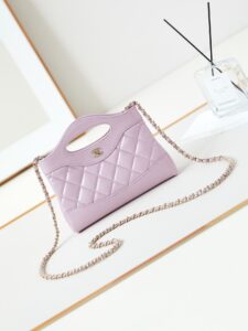 31 Nano Shopping Bag. Authentic quality luxury bag crafted in genuine leather comes with authenticity card, dust bag and gift bag. Small in size, grand in statement. A miniature marvel that captures the sophistication of *ANEL in its most playful form. Crafted with meticulous precision, this petite icon merges the timeless spirit of the *ANEL 31 with a modern twist on everyday elegance. Designed in supple lambskin and finished with gleaming gold-tone hardware, the Nano 31 doesn’t just carry your essentials — it carries your attitude. Whether worn crossbody, by hand, or dangling from the crook of your arm, this charming piece elevates every ensemble with a whisper of Parisian chic. Perfect for a night out or a day in the spotlight, it’s not just a bag — it’s your boldest accessory in its most compact form. Because luxury doesn't need to shout. Sometimes, it just needs to charm.