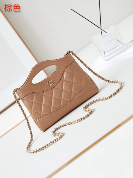 31 Nano Shopping Bag. Authentic quality luxury bag crafted in genuine leather comes with authenticity card, dust bag and gift bag. Small in size, grand in statement. A miniature marvel that captures the sophistication of *ANEL in its most playful form. Crafted with meticulous precision, this petite icon merges the timeless spirit of the *ANEL 31 with a modern twist on everyday elegance. Designed in supple lambskin and finished with gleaming gold-tone hardware, the Nano 31 doesn’t just carry your essentials — it carries your attitude. Whether worn crossbody, by hand, or dangling from the crook of your arm, this charming piece elevates every ensemble with a whisper of Parisian chic. Perfect for a night out or a day in the spotlight, it’s not just a bag — it’s your boldest accessory in its most compact form. Because luxury doesn't need to shout. Sometimes, it just needs to charm.