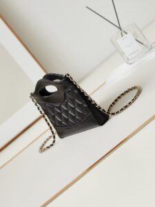 31 Nano Shopping Bag. Authentic quality luxury bag crafted in genuine leather comes with authenticity card, dust bag and gift bag. Small in size, grand in statement. A miniature marvel that captures the sophistication of *ANEL in its most playful form. Crafted with meticulous precision, this petite icon merges the timeless spirit of the *ANEL 31 with a modern twist on everyday elegance. Designed in supple lambskin and finished with gleaming gold-tone hardware, the Nano 31 doesn’t just carry your essentials — it carries your attitude. Whether worn crossbody, by hand, or dangling from the crook of your arm, this charming piece elevates every ensemble with a whisper of Parisian chic. Perfect for a night out or a day in the spotlight, it’s not just a bag — it’s your boldest accessory in its most compact form. Because luxury doesn't need to shout. Sometimes, it just needs to charm.