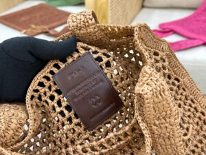 Summer Banana Tote Bag. Authentic quality luxury bag crafted in genuine leather comes with authenticity card, dust bag and gift bag. Heritage in Hand: Where Artisan Craft Meets Summer Elegance. Introducing the Summer Banana Tote—an artisanal masterpiece crafted from raffia and calfskin by a single artisan over 4.5 days in partnership with Made For A Woman. This spacious tote is adorned with a handwritten signature inspired by *loé’s rich heritage, while a playful dangling chain and delicate charms add the perfect finishing touch. A celebration of craftsmanship and effortless summer style. | PURSE POP UP LIVE Summer Banana Tote Bag. Authentic quality luxury bag crafted in genuine leather comes with authenticity card, dust bag and gift bag. Heritage in Hand: Where Artisan Craft Meets Summer Elegance. Introducing the Summer Banana Tote—an artisanal masterpiece crafted from raffia and calfskin by a single artisan over 4.5 days in partnership with Made For A Woman. This spacious tote is adorned with a handwritten signature inspired by *loé’s rich heritage, while a playful dangling chain and delicate charms add the perfect finishing touch. A celebration of craftsmanship and effortless summer style.