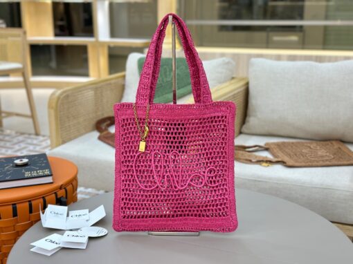 Summer Banana Tote Bag. Authentic quality luxury bag crafted in genuine leather comes with authenticity card, dust bag and gift bag. Heritage in Hand: Where Artisan Craft Meets Summer Elegance. Introducing the Summer Banana Tote—an artisanal masterpiece crafted from raffia and calfskin by a single artisan over 4.5 days in partnership with Made For A Woman. This spacious tote is adorned with a handwritten signature inspired by *loé’s rich heritage, while a playful dangling chain and delicate charms add the perfect finishing touch. A celebration of craftsmanship and effortless summer style.