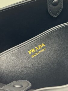 Buckle Small Leather Handbag. Authentic quality luxury bag crafted in genuine leather comes with authenticity card, dust bag and gift bag. Sophistication Meets Utility. Sleek, structured, and undeniably Pr*da — the Buckle Small Leather Handbag captures the brand’s signature balance of minimalist elegance and refined detail. Crafted in smooth leather with a buttery-soft nappa interior, this compact piece is a masterclass in functional luxury. A standout feature? Its interchangeable belt strap, adding a bold, modern twist to the timeless silhouette. Whether you're heading to a meeting or a soirée, this bag adapts seamlessly to your mood and moment. Finished with the embossed iconic logo, it’s a quiet statement of taste and distinction. A versatile companion for the woman who appreciates precision, polish, and just the right touch of edge.