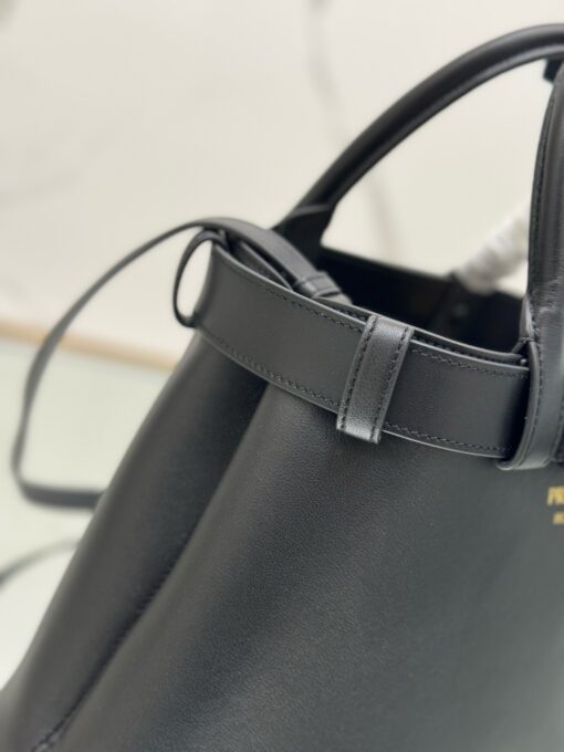 Buckle Small Leather Handbag. Authentic quality luxury bag crafted in genuine leather comes with authenticity card, dust bag and gift bag. Sophistication Meets Utility. Sleek, structured, and undeniably Pr*da — the Buckle Small Leather Handbag captures the brand’s signature balance of minimalist elegance and refined detail. Crafted in smooth leather with a buttery-soft nappa interior, this compact piece is a masterclass in functional luxury. A standout feature? Its interchangeable belt strap, adding a bold, modern twist to the timeless silhouette. Whether you're heading to a meeting or a soirée, this bag adapts seamlessly to your mood and moment. Finished with the embossed iconic logo, it’s a quiet statement of taste and distinction. A versatile companion for the woman who appreciates precision, polish, and just the right touch of edge.