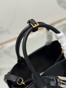 Buckle Small Leather Handbag. Authentic quality luxury bag crafted in genuine leather comes with authenticity card, dust bag and gift bag. Sophistication Meets Utility. Sleek, structured, and undeniably Pr*da — the Buckle Small Leather Handbag captures the brand’s signature balance of minimalist elegance and refined detail. Crafted in smooth leather with a buttery-soft nappa interior, this compact piece is a masterclass in functional luxury. A standout feature? Its interchangeable belt strap, adding a bold, modern twist to the timeless silhouette. Whether you're heading to a meeting or a soirée, this bag adapts seamlessly to your mood and moment. Finished with the embossed iconic logo, it’s a quiet statement of taste and distinction. A versatile companion for the woman who appreciates precision, polish, and just the right touch of edge.