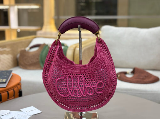 Summer Banana Hobo. Authentic quality luxury bag crafted in genuine leather comes with authenticity card, dust bag and gift bag. Artisanal Spirit, Curved in Style. Say hello to sunshine in bag form. The *LOÉ Summer Banana Hobo Bag is a joyful blend of craftsmanship and creativity, handwoven over four days by a single artisan in collaboration with Made For A Woman. This is not just a bag—it’s a story stitched in raffia and trimmed in luxurious calfskin. Its curved, banana-inspired silhouette hugs the shoulder with ease, while the sculptural handle and handwritten signature nod to *loé’s heritage of effortless elegance. Light, natural, and undeniably chic, it's the perfect companion for sun-soaked escapes or city strolls with a coastal state of mind. A celebration of craftsmanship, femininity, and the art of slow fashion.