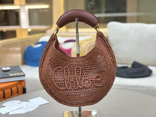 Summer Banana Hobo. Authentic quality luxury bag crafted in genuine leather comes with authenticity card, dust bag and gift bag. Artisanal Spirit, Curved in Style. Say hello to sunshine in bag form. The *LOÉ Summer Banana Hobo Bag is a joyful blend of craftsmanship and creativity, handwoven over four days by a single artisan in collaboration with Made For A Woman. This is not just a bag—it’s a story stitched in raffia and trimmed in luxurious calfskin. Its curved, banana-inspired silhouette hugs the shoulder with ease, while the sculptural handle and handwritten signature nod to *loé’s heritage of effortless elegance. Light, natural, and undeniably chic, it's the perfect companion for sun-soaked escapes or city strolls with a coastal state of mind. A celebration of craftsmanship, femininity, and the art of slow fashion.