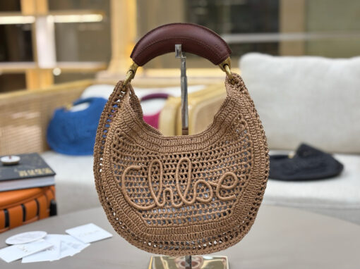 Summer Banana Hobo. Authentic quality luxury bag crafted in genuine leather comes with authenticity card, dust bag and gift bag. Artisanal Spirit, Curved in Style. Say hello to sunshine in bag form. The *LOÉ Summer Banana Hobo Bag is a joyful blend of craftsmanship and creativity, handwoven over four days by a single artisan in collaboration with Made For A Woman. This is not just a bag—it’s a story stitched in raffia and trimmed in luxurious calfskin. Its curved, banana-inspired silhouette hugs the shoulder with ease, while the sculptural handle and handwritten signature nod to *loé’s heritage of effortless elegance. Light, natural, and undeniably chic, it's the perfect companion for sun-soaked escapes or city strolls with a coastal state of mind. A celebration of craftsmanship, femininity, and the art of slow fashion.