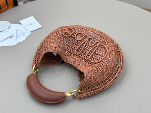 Summer Banana Hobo. Authentic quality luxury bag crafted in genuine leather comes with authenticity card, dust bag and gift bag. Artisanal Spirit, Curved in Style. Say hello to sunshine in bag form. The *LOÉ Summer Banana Hobo Bag is a joyful blend of craftsmanship and creativity, handwoven over four days by a single artisan in collaboration with Made For A Woman. This is not just a bag—it’s a story stitched in raffia and trimmed in luxurious calfskin. Its curved, banana-inspired silhouette hugs the shoulder with ease, while the sculptural handle and handwritten signature nod to *loé’s heritage of effortless elegance. Light, natural, and undeniably chic, it's the perfect companion for sun-soaked escapes or city strolls with a coastal state of mind. A celebration of craftsmanship, femininity, and the art of slow fashion.