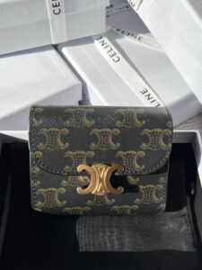 Small Flap Wallet Triomphe. Authentic quality luxury bag crafted in genuine leather comes with authenticity card, dust bag and gift bag. Small in Size, Grand in Style. Discover timeless sophistication in the palm of your hand with the *ELINE Small Flap Wallet TRIOMPHE in shiny calfskin. Meticulously crafted from luxurious leather, this compact beauty showcases the iconic Triomphe clasp in gold-tone metal, a refined nod to Parisian heritage. Despite its petite size, it opens to reveal smart compartments for cards, bills, and coins—proving that style never compromises function. Whether tucked into your favorite designer bag or carried solo for a night out, this wallet is your everyday dose of quiet luxury.