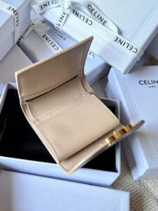 Small Flap Wallet Triomphe. Authentic quality luxury bag crafted in genuine leather comes with authenticity card, dust bag and gift bag. Small in Size, Grand in Style. Discover timeless sophistication in the palm of your hand with the *ELINE Small Flap Wallet TRIOMPHE in shiny calfskin. Meticulously crafted from luxurious leather, this compact beauty showcases the iconic Triomphe clasp in gold-tone metal, a refined nod to Parisian heritage. Despite its petite size, it opens to reveal smart compartments for cards, bills, and coins—proving that style never compromises function. Whether tucked into your favorite designer bag or carried solo for a night out, this wallet is your everyday dose of quiet luxury.