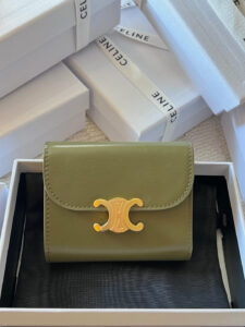 Small Flap Wallet Triomphe. Authentic quality luxury bag crafted in genuine leather comes with authenticity card, dust bag and gift bag. Small in Size, Grand in Style. Discover timeless sophistication in the palm of your hand with the *ELINE Small Flap Wallet TRIOMPHE in shiny calfskin. Meticulously crafted from luxurious leather, this compact beauty showcases the iconic Triomphe clasp in gold-tone metal, a refined nod to Parisian heritage. Despite its petite size, it opens to reveal smart compartments for cards, bills, and coins—proving that style never compromises function. Whether tucked into your favorite designer bag or carried solo for a night out, this wallet is your everyday dose of quiet luxury.