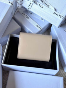 Small Flap Wallet Triomphe. Authentic quality luxury bag crafted in genuine leather comes with authenticity card, dust bag and gift bag. Small in Size, Grand in Style. Discover timeless sophistication in the palm of your hand with the *ELINE Small Flap Wallet TRIOMPHE in shiny calfskin. Meticulously crafted from luxurious leather, this compact beauty showcases the iconic Triomphe clasp in gold-tone metal, a refined nod to Parisian heritage. Despite its petite size, it opens to reveal smart compartments for cards, bills, and coins—proving that style never compromises function. Whether tucked into your favorite designer bag or carried solo for a night out, this wallet is your everyday dose of quiet luxury.