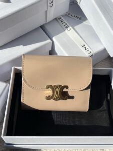 Small Flap Wallet Triomphe. Authentic quality luxury bag crafted in genuine leather comes with authenticity card, dust bag and gift bag. Small in Size, Grand in Style. Discover timeless sophistication in the palm of your hand with the *ELINE Small Flap Wallet TRIOMPHE in shiny calfskin. Meticulously crafted from luxurious leather, this compact beauty showcases the iconic Triomphe clasp in gold-tone metal, a refined nod to Parisian heritage. Despite its petite size, it opens to reveal smart compartments for cards, bills, and coins—proving that style never compromises function. Whether tucked into your favorite designer bag or carried solo for a night out, this wallet is your everyday dose of quiet luxury.