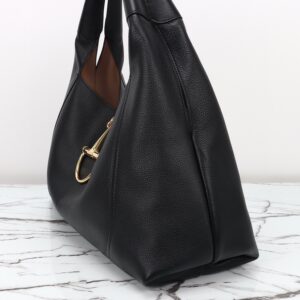 Softbit Maxi Shoulder Bag. Authentic quality luxury bag crafted in genuine leather comes with authenticity card, dust bag and gift bag. Icon Reimagined: Effortless Luxury with a Modern Bit of Bold. Gucci’s timeless heritage meets contemporary ease in the new Softbit Shoulder Bag. Crafted from supple grained leather with a luxuriously rich texture, this piece balances sophistication and function effortlessly. At its heart lies an oversized half-horsebit — a bold reinterpretation of the House’s iconic detail — accenting the magnetic closure with statement appeal. With its relaxed silhouette and refined craftsmanship, the Softbit is the perfect companion for those who favor effortless elegance with a modern edge.