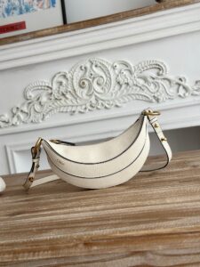 Banana Cross-Body Bag.  Authentic quality luxury bag crafted in genuine leather comes with authenticity card, dust bag and gift bag. Playful Design, Iconic Craftsmanship Meet your new style statement: the *LOÉ Banana, a charming cross-body bag crafted from luxurious shiny grained calfskin. Inspired by *loé’s legendary Spring 2001 collection, its sculptural, banana-shaped silhouette highlights the Maison’s signature artistry with a refined 3D textured effect. Perfectly sized to hold your phone, cardholder, and daily essentials, this lighthearted yet sophisticated accessory blends practicality with Parisian elegance. An adjustable strap allows effortless shoulder or crossbody wear, making it your go-anywhere companion.