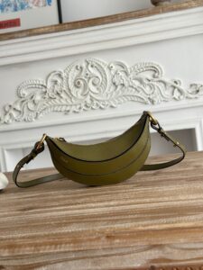 Banana Cross-Body Bag.  Authentic quality luxury bag crafted in genuine leather comes with authenticity card, dust bag and gift bag. Playful Design, Iconic Craftsmanship Meet your new style statement: the *LOÉ Banana, a charming cross-body bag crafted from luxurious shiny grained calfskin. Inspired by *loé’s legendary Spring 2001 collection, its sculptural, banana-shaped silhouette highlights the Maison’s signature artistry with a refined 3D textured effect. Perfectly sized to hold your phone, cardholder, and daily essentials, this lighthearted yet sophisticated accessory blends practicality with Parisian elegance. An adjustable strap allows effortless shoulder or crossbody wear, making it your go-anywhere companion.