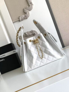 25 Small Handbag.  Authentic quality luxury bag crafted in genuine leather comes with authenticity card, dust bag and gift bag. Sleek, Sculptural, and Bold. A striking fusion of elegance and modernity, the *ANEL 25 Small is crafted in calfskin that catches the light with every curve. This piece from the Fall-Winter 2025/26 collection blends soft texture with architectural precision. Refined yet edgy, it features a gold-tone chain strap and double-C clasps, delivering the signature *ANEL aesthetic in a fresh, contemporary way. With a roomy interior, the 25 Small balances wearability and luxury — perfect for day-to-evening sophistication. Explore the essence of *ANEL in a design that celebrates texture, volume, and heritage.