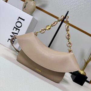 Medium Ola Bag. Authentic quality luxury bag crafted in genuine leather comes with authenticity card, dust bag and gift bag. Soft Curves, Bold Style. Introducing the *OEWE Ola Bag — Where Fluid Design Meets Effortless Luxury. This Ola bag is your new summer essential: soft, lightweight, and irresistibly modern. Defined by its beautifully curved silhouette, flowing flap, and iconic donut chain detail, this piece blends sculptural elegance with everyday practicality. Crafted in smooth, premium calfskin, the medium Ola offers a refined touch while remaining exceptionally versatile. Whether worn for daytime ease or evening polish, it elevates any look with its understated yet striking aesthetic. A statement of craftsmanship. A celebration of movement. A summer icon in the making.