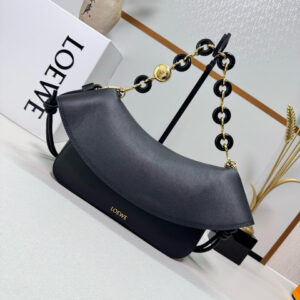 Medium Ola Bag. Authentic quality luxury bag crafted in genuine leather comes with authenticity card, dust bag and gift bag. Soft Curves, Bold Style. Introducing the *OEWE Ola Bag — Where Fluid Design Meets Effortless Luxury. This Ola bag is your new summer essential: soft, lightweight, and irresistibly modern. Defined by its beautifully curved silhouette, flowing flap, and iconic donut chain detail, this piece blends sculptural elegance with everyday practicality. Crafted in smooth, premium calfskin, the medium Ola offers a refined touch while remaining exceptionally versatile. Whether worn for daytime ease or evening polish, it elevates any look with its understated yet striking aesthetic. A statement of craftsmanship. A celebration of movement. A summer icon in the making.