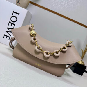 Medium Ola Bag. Authentic quality luxury bag crafted in genuine leather comes with authenticity card, dust bag and gift bag. Soft Curves, Bold Style. Introducing the *OEWE Ola Bag — Where Fluid Design Meets Effortless Luxury. This Ola bag is your new summer essential: soft, lightweight, and irresistibly modern. Defined by its beautifully curved silhouette, flowing flap, and iconic donut chain detail, this piece blends sculptural elegance with everyday practicality. Crafted in smooth, premium calfskin, the medium Ola offers a refined touch while remaining exceptionally versatile. Whether worn for daytime ease or evening polish, it elevates any look with its understated yet striking aesthetic. A statement of craftsmanship. A celebration of movement. A summer icon in the making.