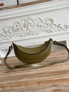 Banana Cross-Body Bag.  Authentic quality luxury bag crafted in genuine leather comes with authenticity card, dust bag and gift bag. Playful Design, Iconic Craftsmanship Meet your new style statement: the *LOÉ Banana, a charming cross-body bag crafted from luxurious shiny grained calfskin. Inspired by *loé’s legendary Spring 2001 collection, its sculptural, banana-shaped silhouette highlights the Maison’s signature artistry with a refined 3D textured effect. Perfectly sized to hold your phone, cardholder, and daily essentials, this lighthearted yet sophisticated accessory blends practicality with Parisian elegance. An adjustable strap allows effortless shoulder or crossbody wear, making it your go-anywhere companion.