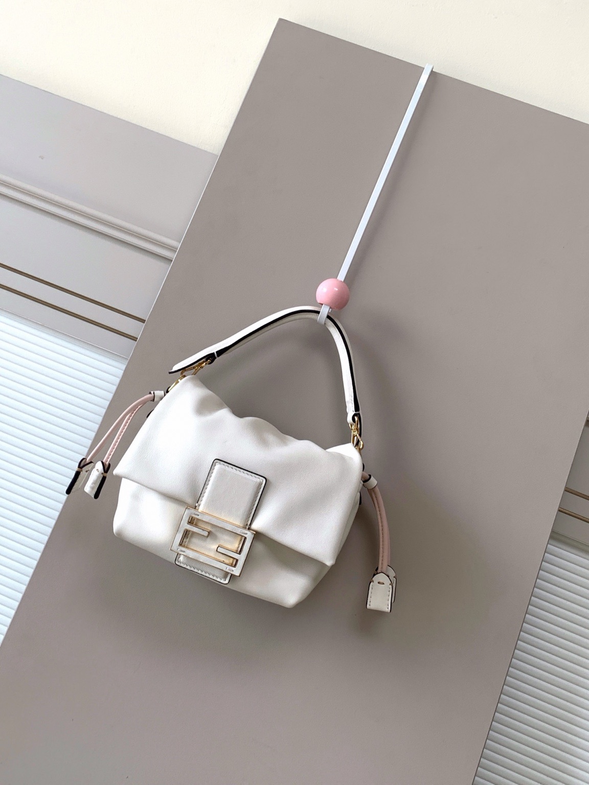 Mamma Baguette Small 7 Small Mamma Baguette. Authentic quality luxury bag crafted in genuine leather comes with authenticity card, dust bag and gift bag. A Soft Revival of an Icon. Born in the late ’90s as the effortlessly chic “big sister” to the original, the Mamma Baguette returns for Spring/Summer 2025 with a modern, deconstructed allure. Reimagined in dreamy nappa leather, it blends nostalgia with a fresh, fluid silhouette that feels both relaxed and refined. An oversized FF clasp, accented with a tonal leather insert, anchors the design with signature *ENDI attitude. Inside, a generously sized suede-lined compartment with a drawstring closure and ties offers both luxury and practicality. Finished with gold-tone hardware and complete with detachable handle and shoulder strap, it transitions seamlessly from hand-held elegance to crossbody ease. Soft, iconic, and undeniably modern—the Mamma Baguette is back, and better than ever.