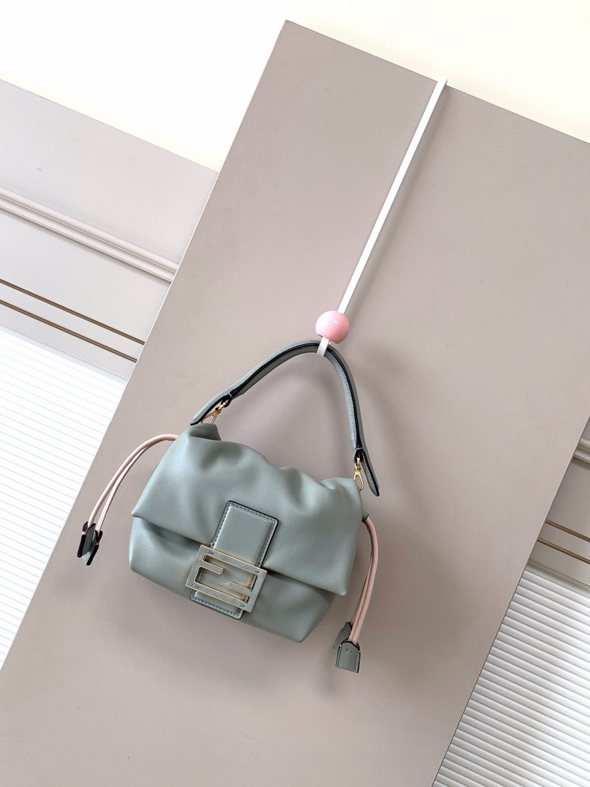 Mamma Baguette Small 6 Small Mamma Baguette. Authentic quality luxury bag crafted in genuine leather comes with authenticity card, dust bag and gift bag. A Soft Revival of an Icon. Born in the late ’90s as the effortlessly chic “big sister” to the original, the Mamma Baguette returns for Spring/Summer 2025 with a modern, deconstructed allure. Reimagined in dreamy nappa leather, it blends nostalgia with a fresh, fluid silhouette that feels both relaxed and refined. An oversized FF clasp, accented with a tonal leather insert, anchors the design with signature *ENDI attitude. Inside, a generously sized suede-lined compartment with a drawstring closure and ties offers both luxury and practicality. Finished with gold-tone hardware and complete with detachable handle and shoulder strap, it transitions seamlessly from hand-held elegance to crossbody ease. Soft, iconic, and undeniably modern—the Mamma Baguette is back, and better than ever.