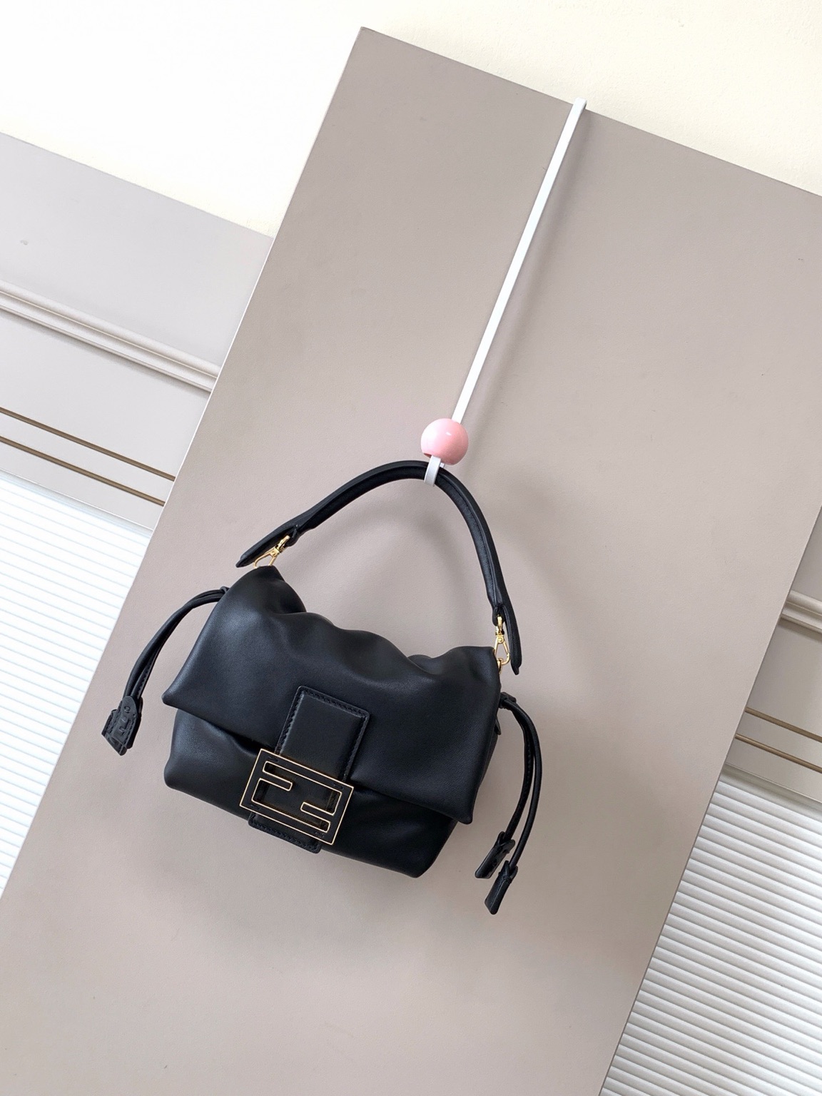 Mamma Baguette Small 3 Small Mamma Baguette. Authentic quality luxury bag crafted in genuine leather comes with authenticity card, dust bag and gift bag. A Soft Revival of an Icon. Born in the late ’90s as the effortlessly chic “big sister” to the original, the Mamma Baguette returns for Spring/Summer 2025 with a modern, deconstructed allure. Reimagined in dreamy nappa leather, it blends nostalgia with a fresh, fluid silhouette that feels both relaxed and refined. An oversized FF clasp, accented with a tonal leather insert, anchors the design with signature *ENDI attitude. Inside, a generously sized suede-lined compartment with a drawstring closure and ties offers both luxury and practicality. Finished with gold-tone hardware and complete with detachable handle and shoulder strap, it transitions seamlessly from hand-held elegance to crossbody ease. Soft, iconic, and undeniably modern—the Mamma Baguette is back, and better than ever.