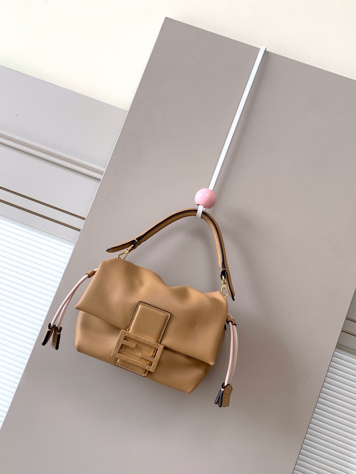 Mamma Baguette Small 2 Small Mamma Baguette. Authentic quality luxury bag crafted in genuine leather comes with authenticity card, dust bag and gift bag. A Soft Revival of an Icon. Born in the late ’90s as the effortlessly chic “big sister” to the original, the Mamma Baguette returns for Spring/Summer 2025 with a modern, deconstructed allure. Reimagined in dreamy nappa leather, it blends nostalgia with a fresh, fluid silhouette that feels both relaxed and refined. An oversized FF clasp, accented with a tonal leather insert, anchors the design with signature *ENDI attitude. Inside, a generously sized suede-lined compartment with a drawstring closure and ties offers both luxury and practicality. Finished with gold-tone hardware and complete with detachable handle and shoulder strap, it transitions seamlessly from hand-held elegance to crossbody ease. Soft, iconic, and undeniably modern—the Mamma Baguette is back, and better than ever.