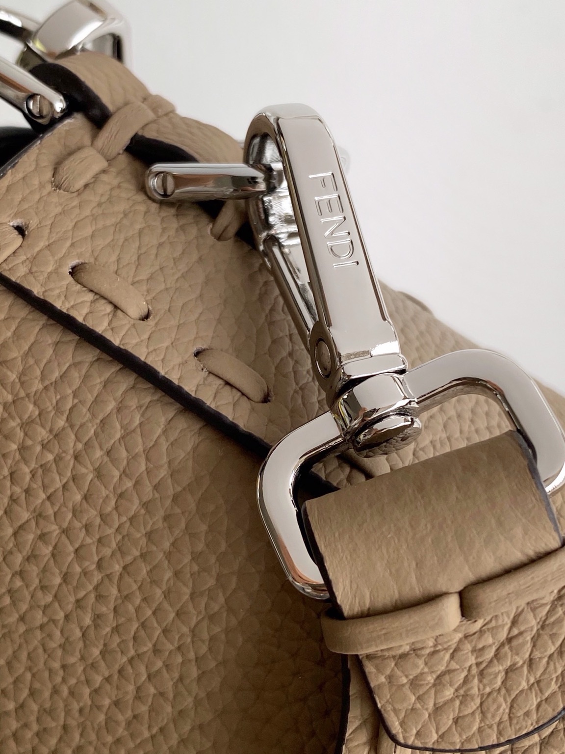 Baguette Medium 10 Baguette Medium. Authentic quality luxury bag crafted in genuine leather comes with authenticity card, dust bag and gift bag. A Legacy in Every Stitch. An icon, reimagined with artisanal mastery—the *ENDI Medium Baguette is a tribute to heritage and timeless design. Crafted in rich cappuccino Cuoio Romano leather, this piece features 612 hand-sewn tone-on-tone macro topstitches, showcasing the legendary Selleria craftsmanship passed down since 1925. Its structured silhouette is elevated by the signature FF clasp, while the soft calfskin interior, complete with a zip pocket, keeps essentials elegantly organized. Finished with a silver Selleria plaque and palladium-finish hardware, every detail speaks of quiet luxury. Versatility meets sophistication with a detachable handle and shoulder strap, allowing it to be carried by hand, worn on the shoulder, or styled cross-body. A true icon—crafted by hand, designed to last a lifetime.