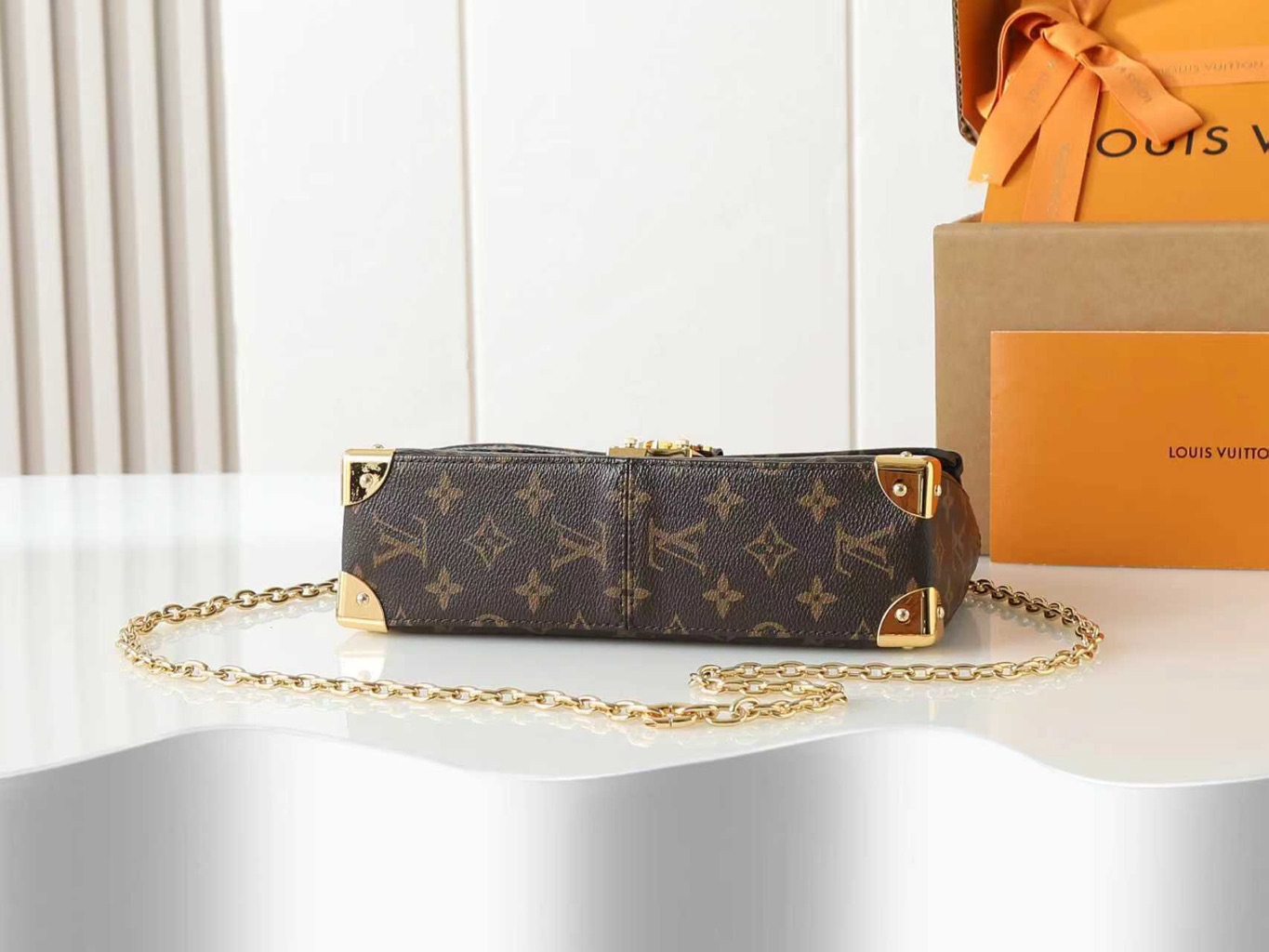 Trunkie 9 Trunkie. Authentic quality luxury bag crafted in genuine leather comes with authenticity card, dust bag and gift bag. Heritage, Reimagined for Today. A bold tribute to the House’s storied past, the Trunkie brings the spirit of vintage travel into a sleek, modern silhouette. Crafted in iconic Monogram canvas and adorned with 38 gold-toned rivets, it echoes the timeless charm of classic LV trunks. Metallic corners and the signature S-lock closure elevate its structured design, while the sliding chain offers versatile styling—from shoulder to crossbody with effortless ease. Inside, a thoughtfully sized interior with a zipped pocket keeps your essentials perfectly organized. Where history meets modern sophistication, the Trunkie is more than a bag—it’s a statement of enduring luxury.