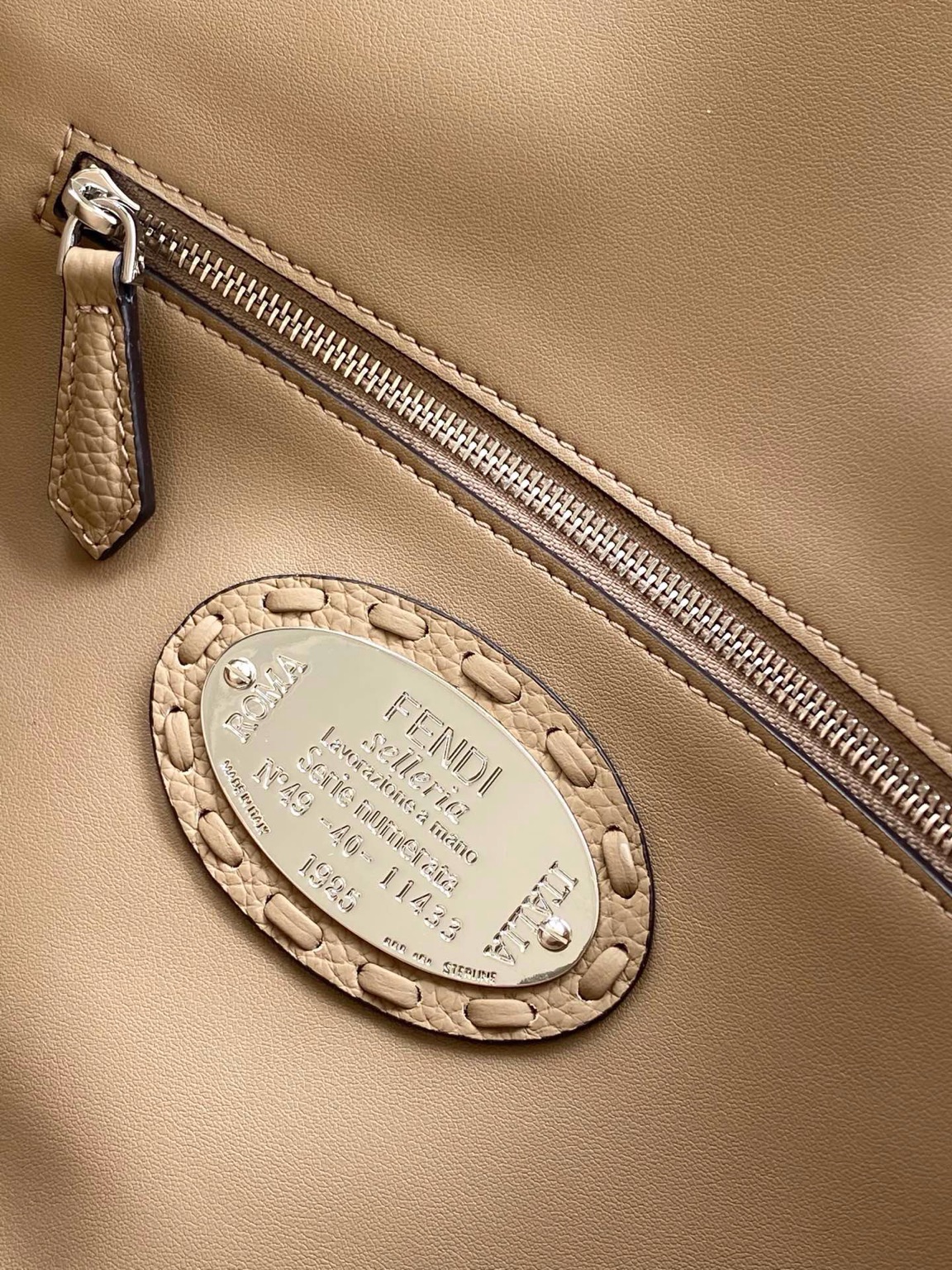 Baguette Medium 8 Baguette Medium. Authentic quality luxury bag crafted in genuine leather comes with authenticity card, dust bag and gift bag. A Legacy in Every Stitch. An icon, reimagined with artisanal mastery—the *ENDI Medium Baguette is a tribute to heritage and timeless design. Crafted in rich cappuccino Cuoio Romano leather, this piece features 612 hand-sewn tone-on-tone macro topstitches, showcasing the legendary Selleria craftsmanship passed down since 1925. Its structured silhouette is elevated by the signature FF clasp, while the soft calfskin interior, complete with a zip pocket, keeps essentials elegantly organized. Finished with a silver Selleria plaque and palladium-finish hardware, every detail speaks of quiet luxury. Versatility meets sophistication with a detachable handle and shoulder strap, allowing it to be carried by hand, worn on the shoulder, or styled cross-body. A true icon—crafted by hand, designed to last a lifetime.