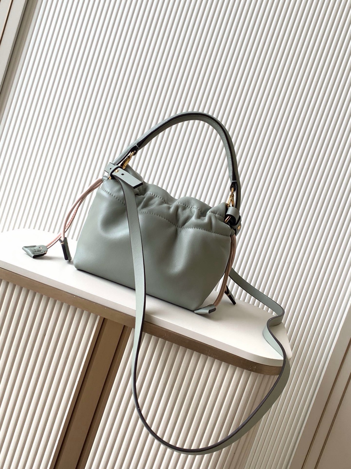 Mamma Baguette Small 8 Small Mamma Baguette. Authentic quality luxury bag crafted in genuine leather comes with authenticity card, dust bag and gift bag. A Soft Revival of an Icon. Born in the late ’90s as the effortlessly chic “big sister” to the original, the Mamma Baguette returns for Spring/Summer 2025 with a modern, deconstructed allure. Reimagined in dreamy nappa leather, it blends nostalgia with a fresh, fluid silhouette that feels both relaxed and refined. An oversized FF clasp, accented with a tonal leather insert, anchors the design with signature *ENDI attitude. Inside, a generously sized suede-lined compartment with a drawstring closure and ties offers both luxury and practicality. Finished with gold-tone hardware and complete with detachable handle and shoulder strap, it transitions seamlessly from hand-held elegance to crossbody ease. Soft, iconic, and undeniably modern—the Mamma Baguette is back, and better than ever.