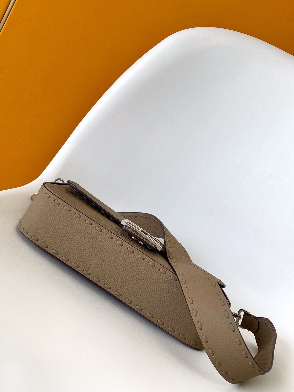 Baguette Medium 3 Baguette Medium. Authentic quality luxury bag crafted in genuine leather comes with authenticity card, dust bag and gift bag. A Legacy in Every Stitch. An icon, reimagined with artisanal mastery—the *ENDI Medium Baguette is a tribute to heritage and timeless design. Crafted in rich cappuccino Cuoio Romano leather, this piece features 612 hand-sewn tone-on-tone macro topstitches, showcasing the legendary Selleria craftsmanship passed down since 1925. Its structured silhouette is elevated by the signature FF clasp, while the soft calfskin interior, complete with a zip pocket, keeps essentials elegantly organized. Finished with a silver Selleria plaque and palladium-finish hardware, every detail speaks of quiet luxury. Versatility meets sophistication with a detachable handle and shoulder strap, allowing it to be carried by hand, worn on the shoulder, or styled cross-body. A true icon—crafted by hand, designed to last a lifetime.
