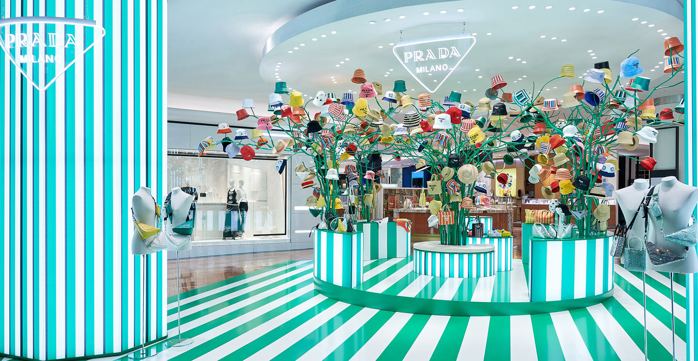 Home 2 Colorful Prada pop-up store featuring a striped interior and sculptural display of hats and accessories.